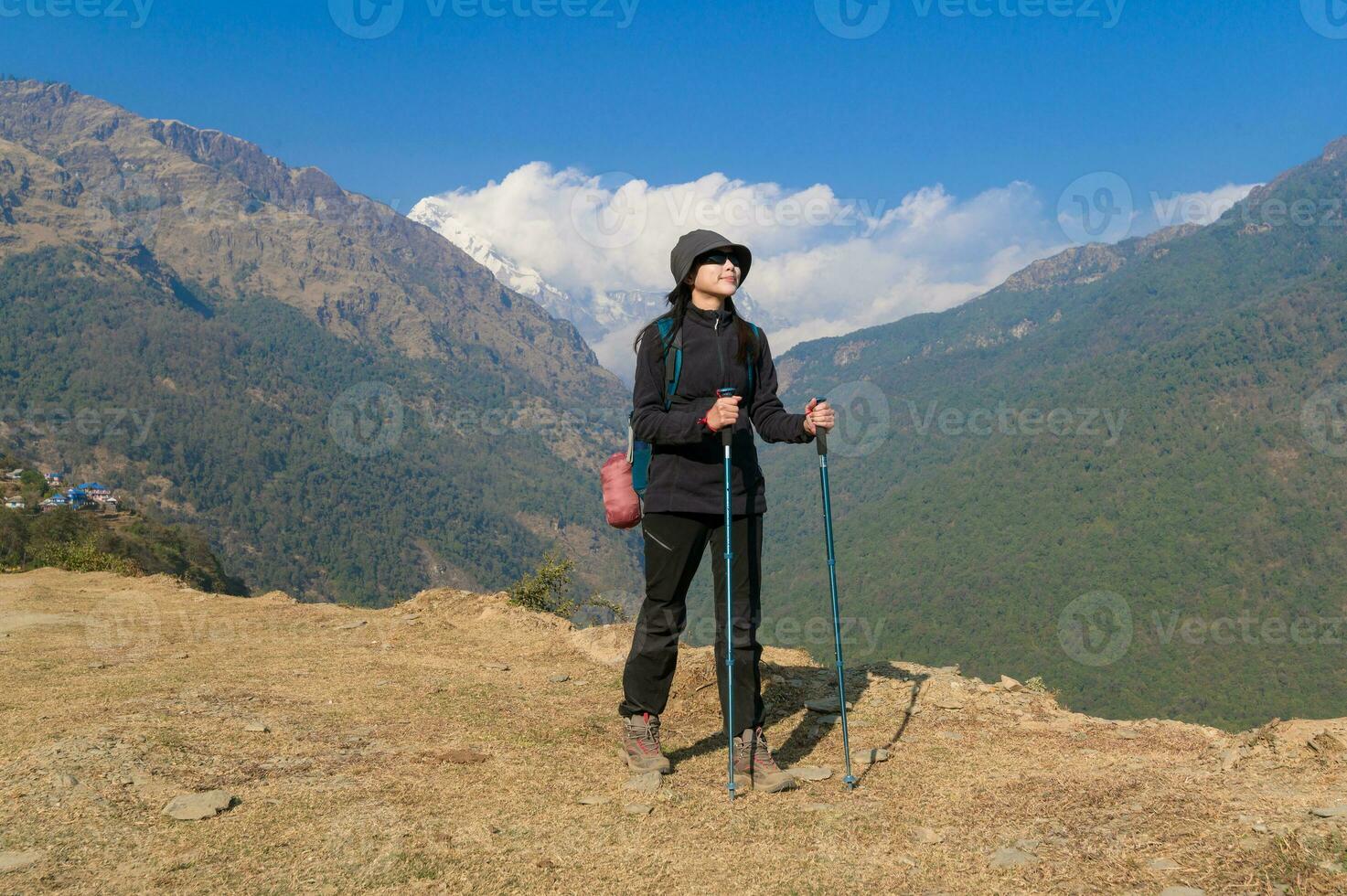 A young traveller trekking on forest trail , Nepal photo
