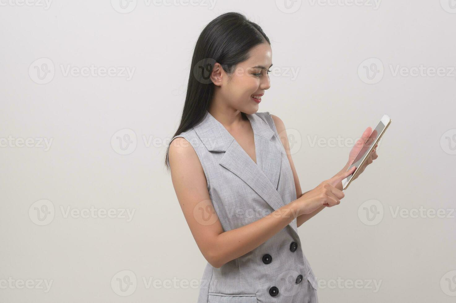 Beautiful woman using tablet over white background, technology concept. photo