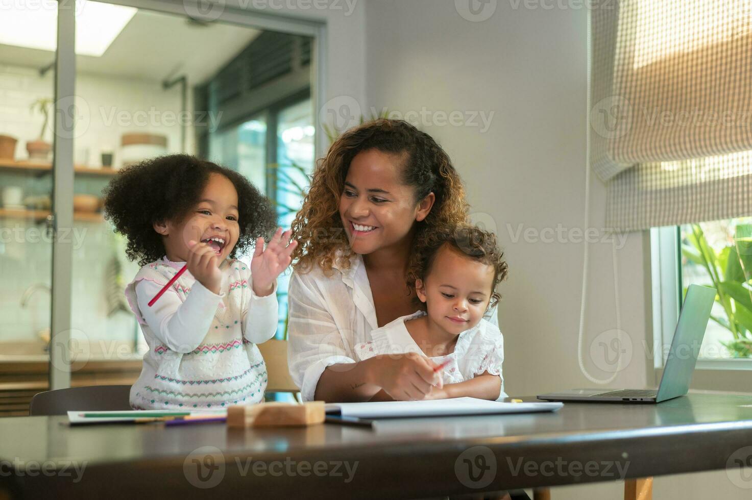 African American mother playing with her daughters in home photo