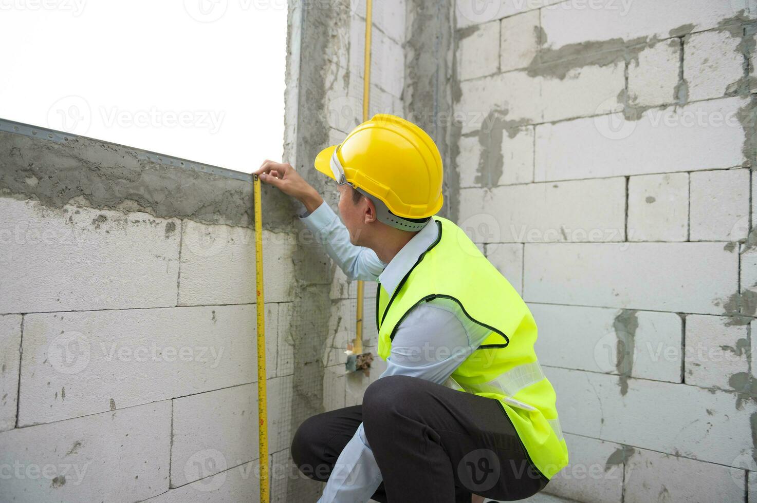 un asiático Ingenieria hombre vistiendo la seguridad casco comprobación construcción sitio analizando acerca de proyecto Progreso foto