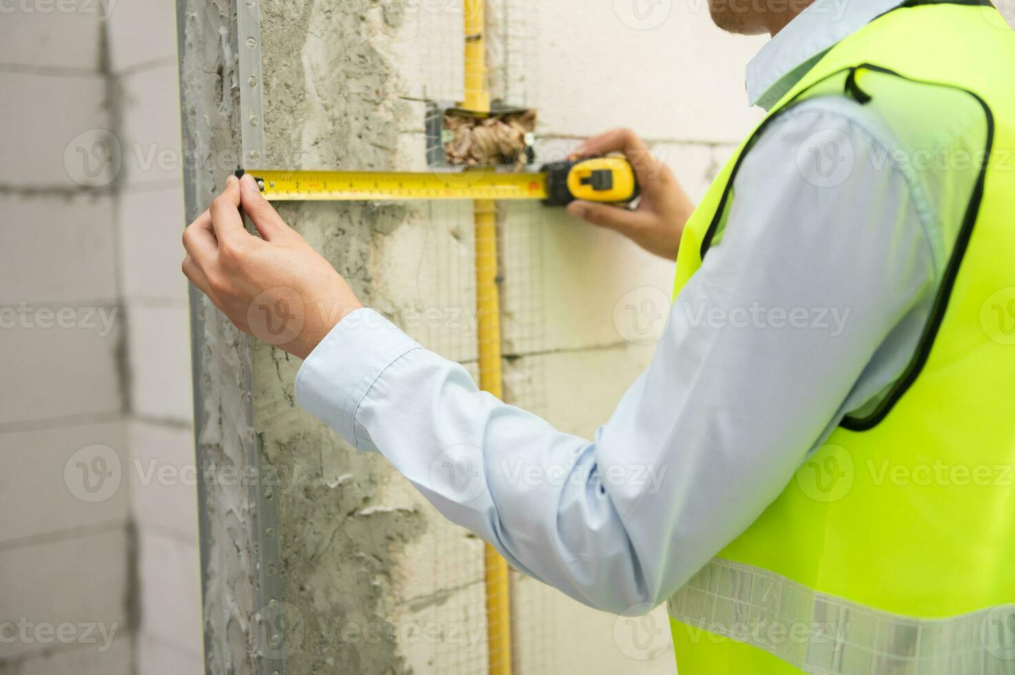 An Asian Engineering man wearing safety helmet checking construction site analyzing about project progress photo