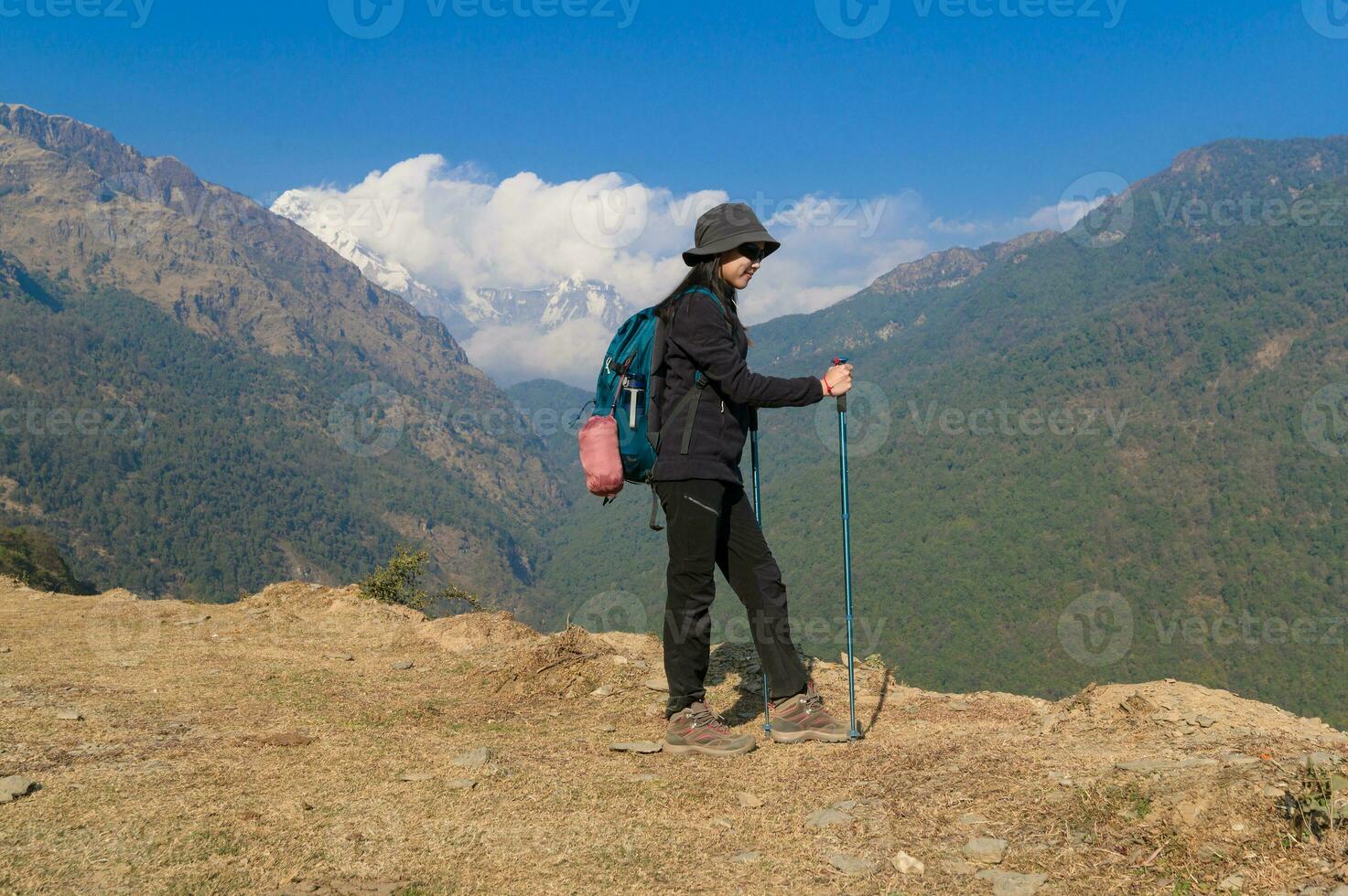 A young traveller trekking on forest trail , Nepal photo