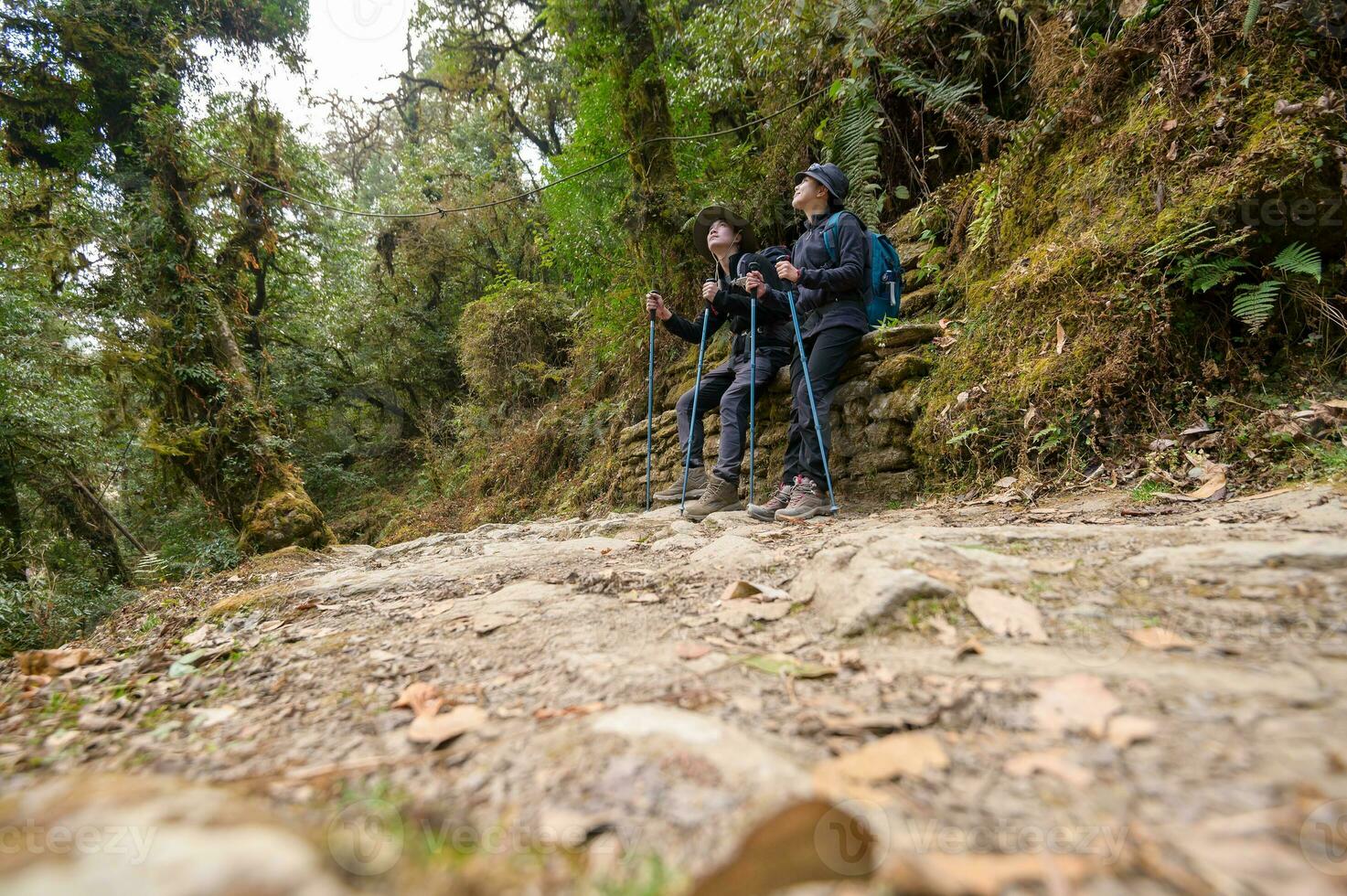 A young couple travellers trekking in Poon Hill view point in Ghorepani, Nepal photo