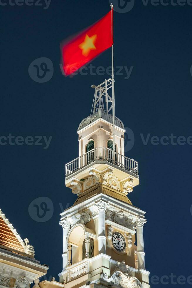 Ho Chi Minh, Viet Nam - 10 April 2023 Saigon City Hall, Vincom Center towers, colorful street traffic and tropical plants against the amazing night. Saigon downtown with its famous landmarks. photo