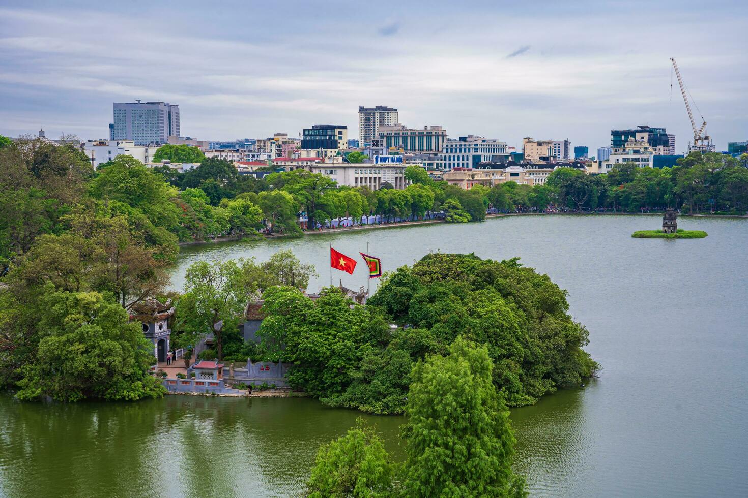 Hanoi, Viet Nam - 13 May 2023 Aerial view of Hoan Kiem Lake  Ho Guom or Sword lake in the center of Hanoi in the fog in the morning. Hoan Kiem Lake is a famous tourist place in Hanoi. Travel concept photo