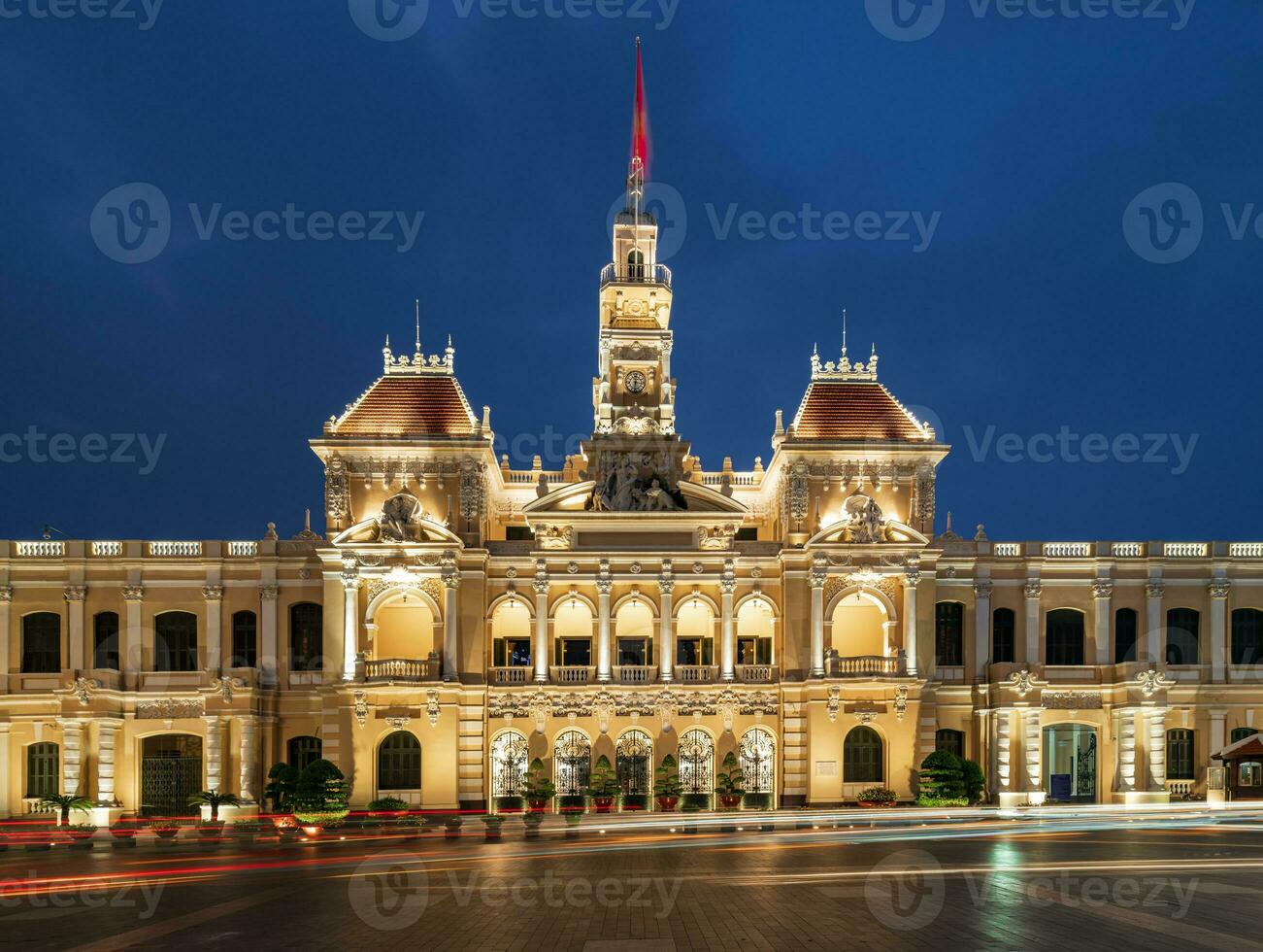 Ho Chi Minh, Viet Nam - 10 April 2023 Saigon City Hall, Vincom Center towers, colorful street traffic and tropical plants against the amazing night. Saigon downtown with its famous landmarks. photo