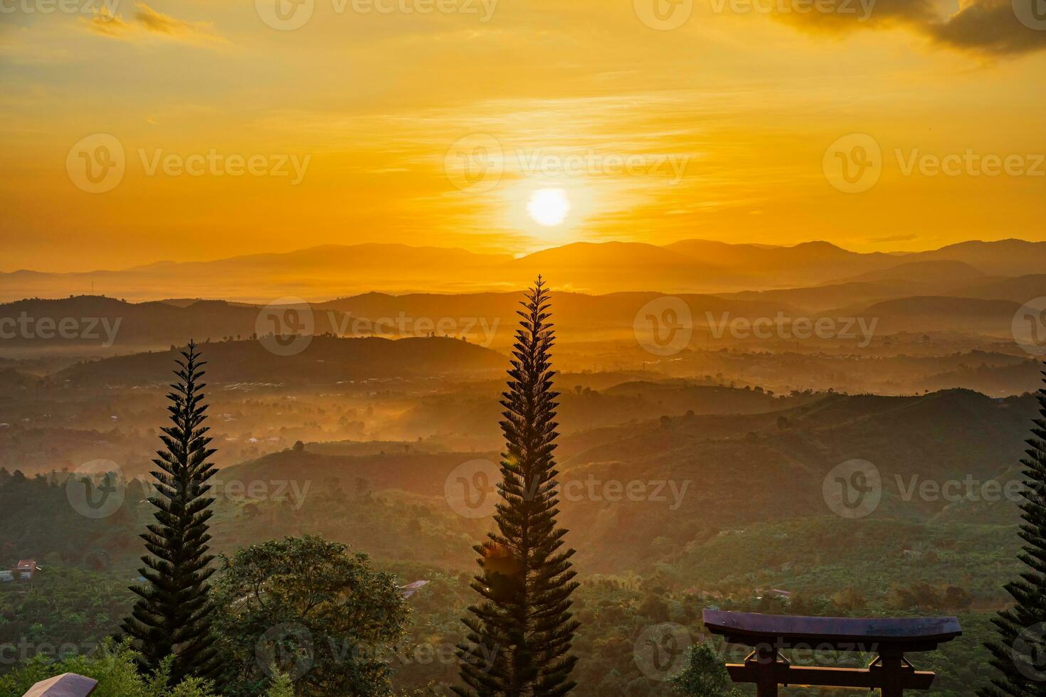 Mountain range with visible silhouettes through the morning colorful fog photo