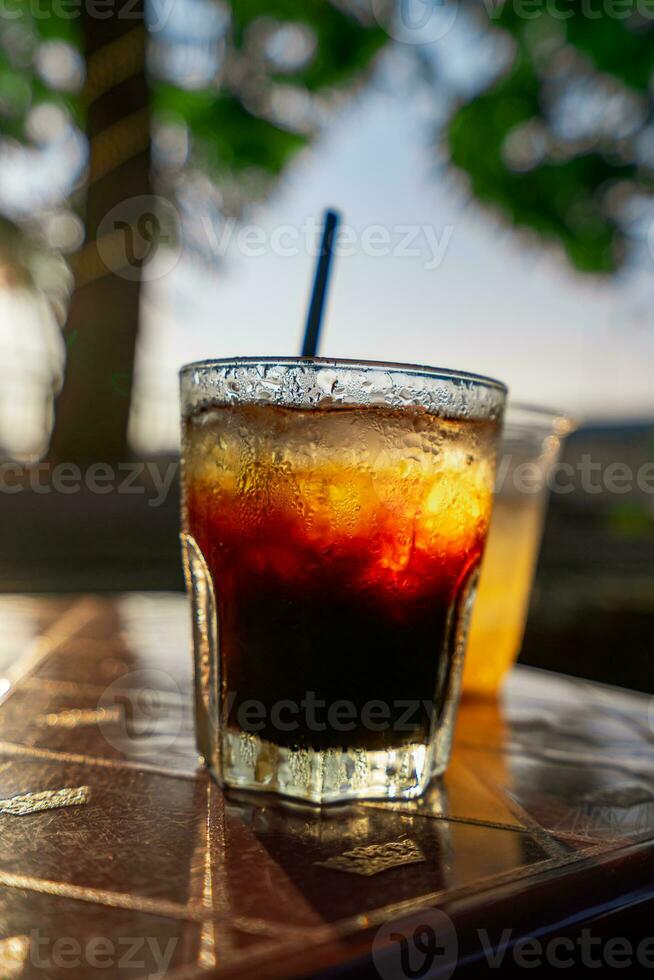 Delicious ice coffee americano on table. photo