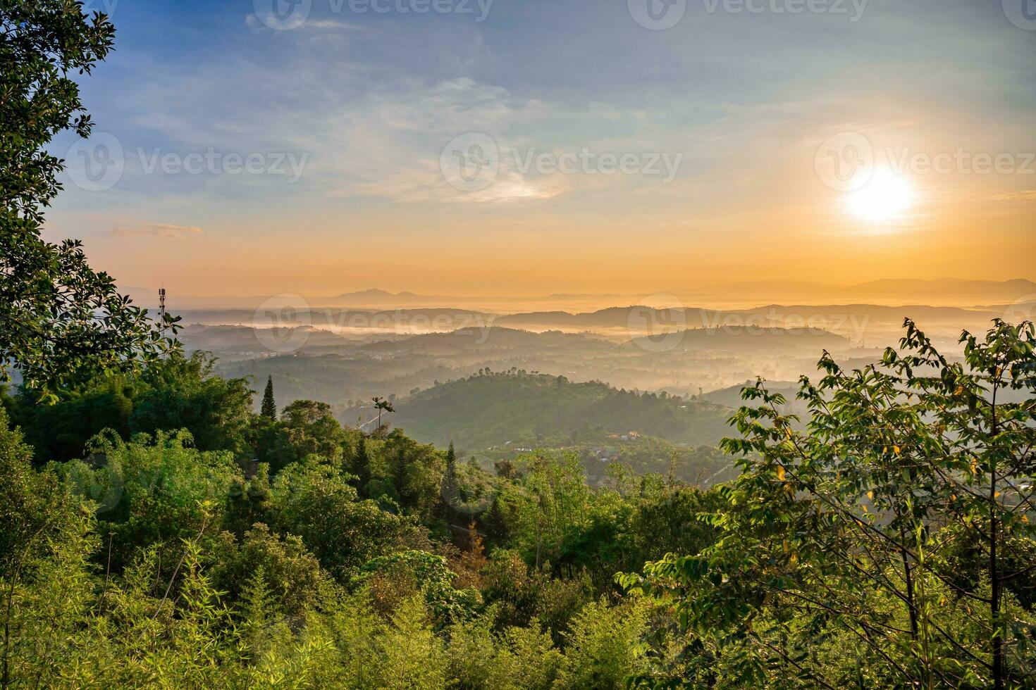 Mountain range with visible silhouettes through the morning colorful fog photo