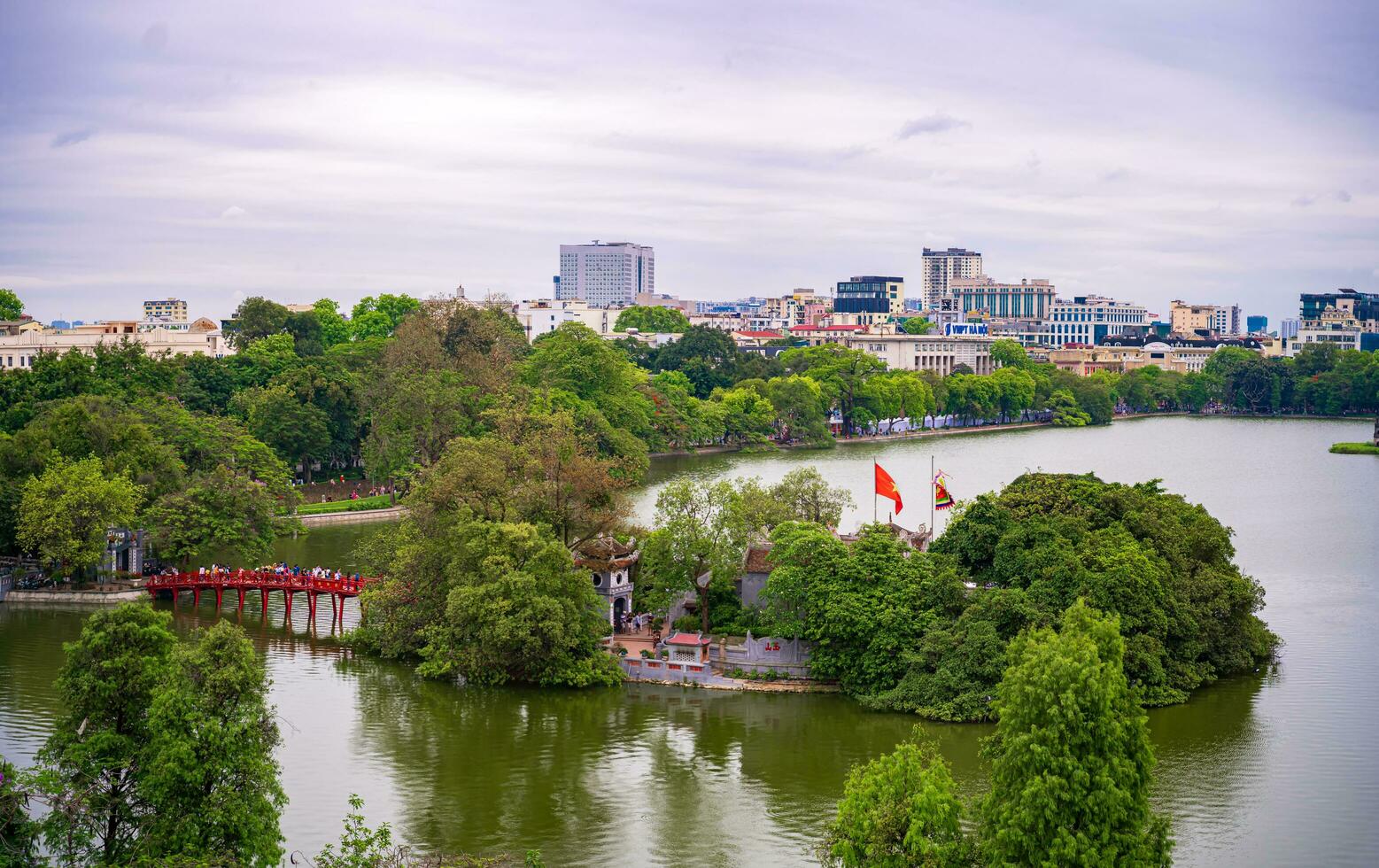 Hanoi, Viet Nam - 13 May 2023 Aerial view of Hoan Kiem Lake  Ho Guom or Sword lake in the center of Hanoi in the fog in the morning. Hoan Kiem Lake is a famous tourist place in Hanoi. Travel concept photo