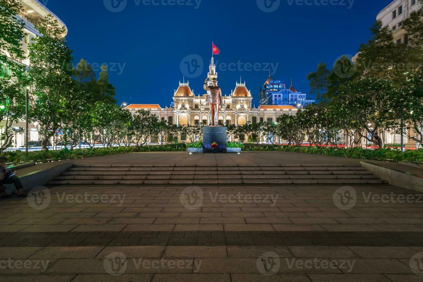 Ho Chi Minh, Viet Nam - 10 April 2023 Saigon City Hall, Vincom Center towers, colorful street traffic and tropical plants against the amazing night. Saigon downtown with its famous landmarks. photo