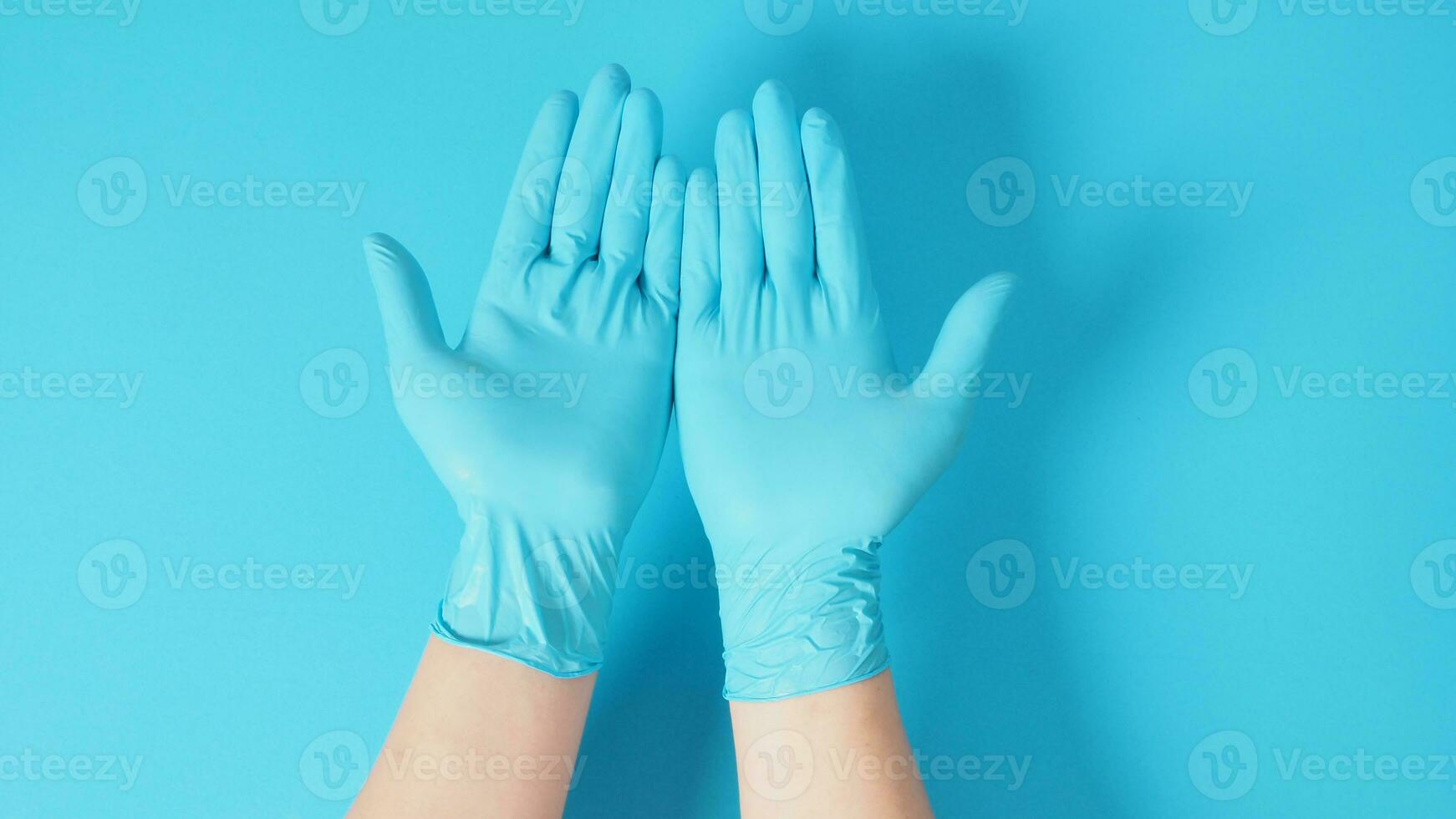 Empty two hand with gloves on blue background. photo