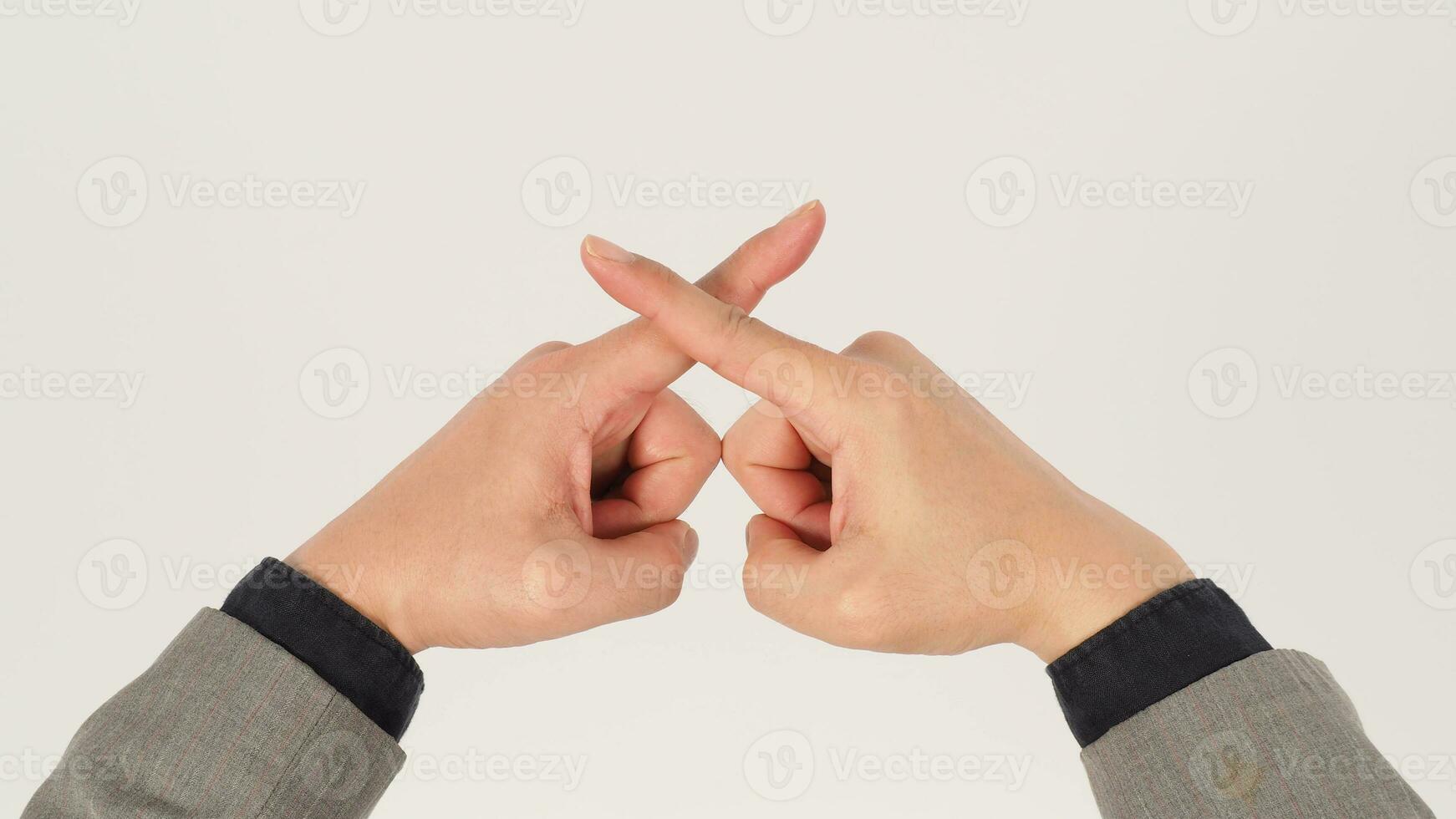 Forbidden or rejection hand sign in a gray suit on white background. Studio shooting. photo