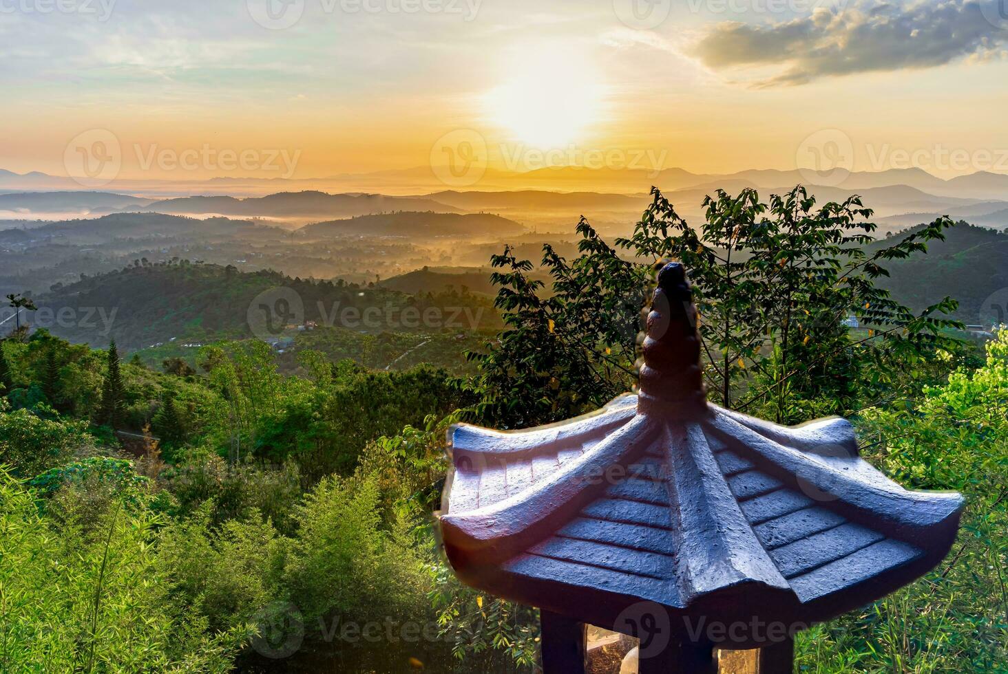 Mountain range with visible silhouettes through the morning colorful fog photo