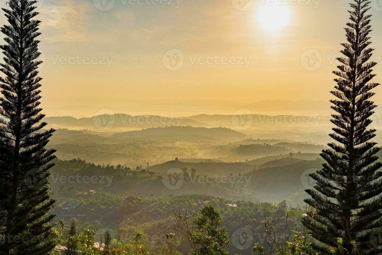 Mountain range with visible silhouettes through the morning colorful fog photo