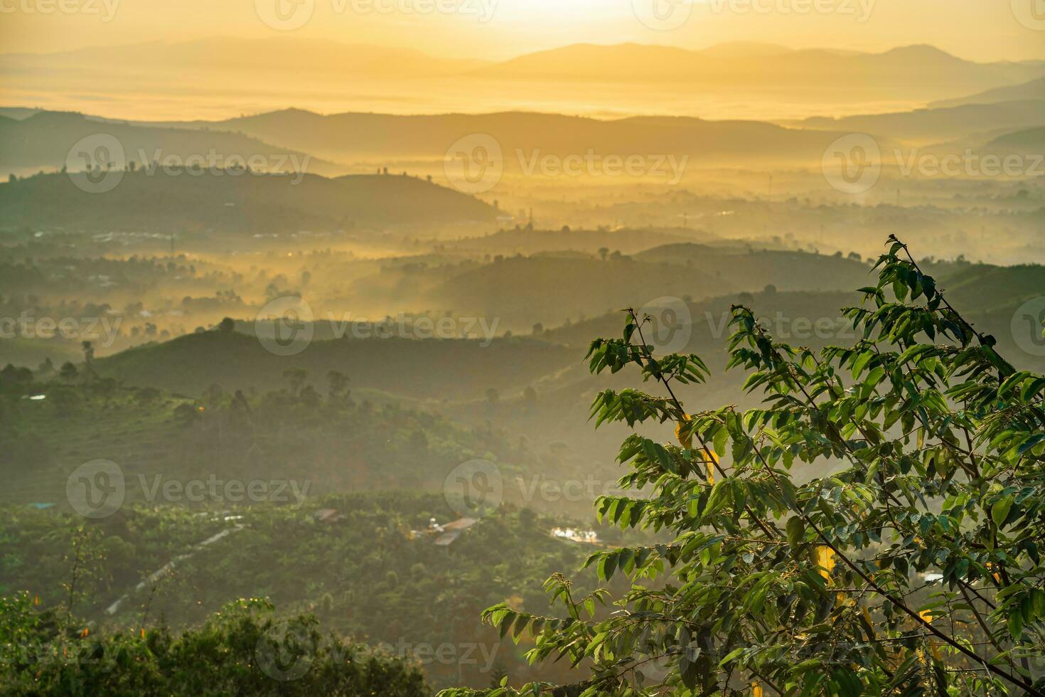 Mountain range with visible silhouettes through the morning colorful fog photo