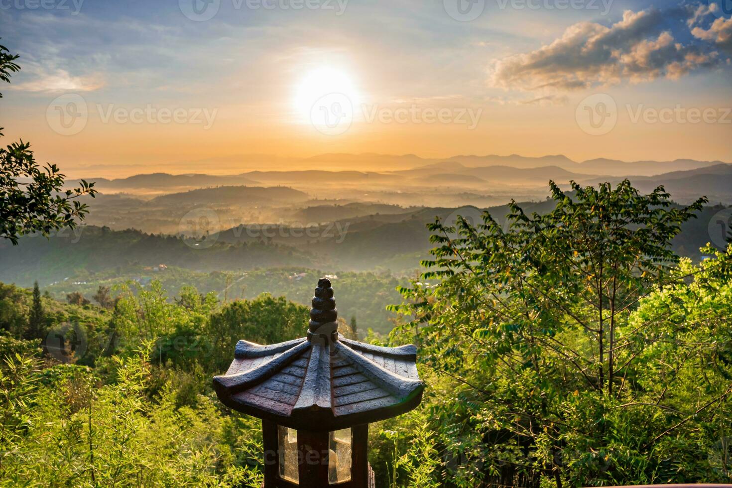 Mountain range with visible silhouettes through the morning colorful fog photo