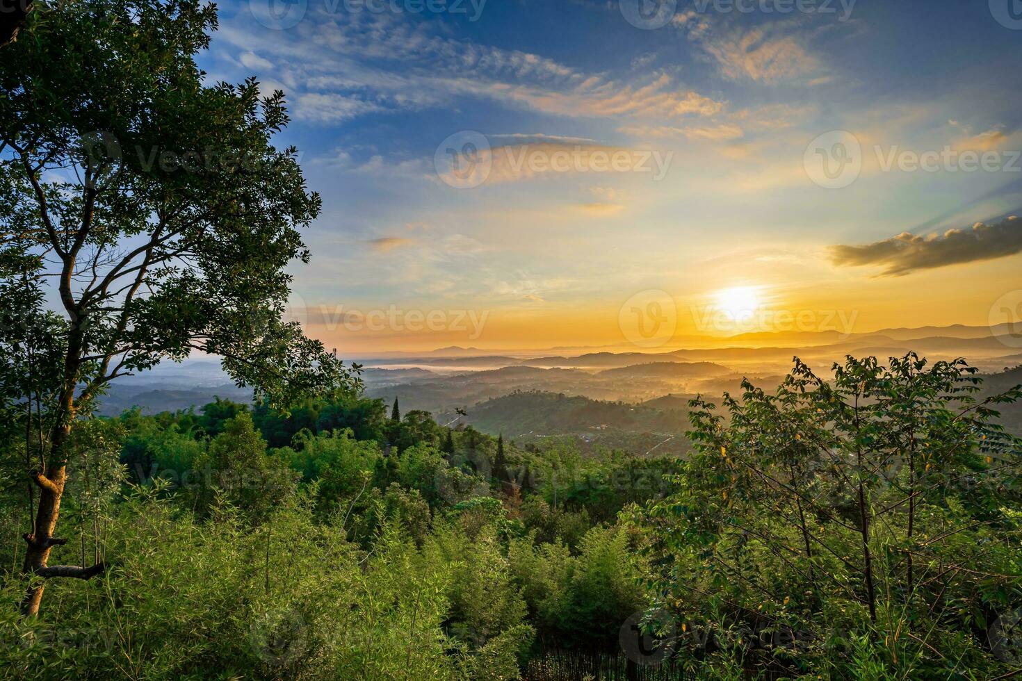 Mountain range with visible silhouettes through the morning colorful fog photo