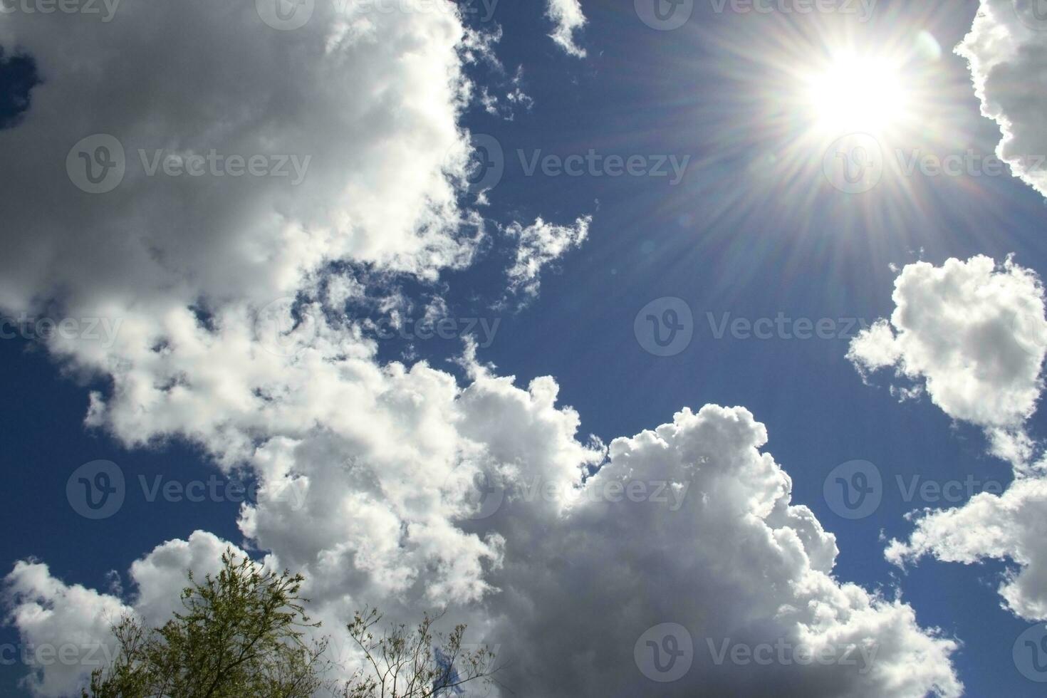 heavenly sky between the white clouds and the radiant sun photo