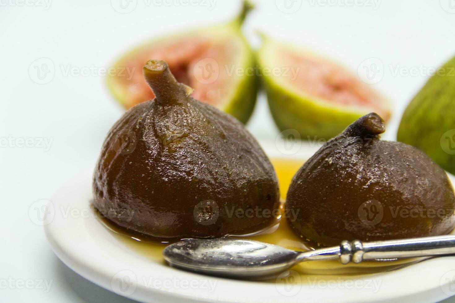 Figs in syrup . Dessert that is accompanied with fresh cheese and walnuts photo