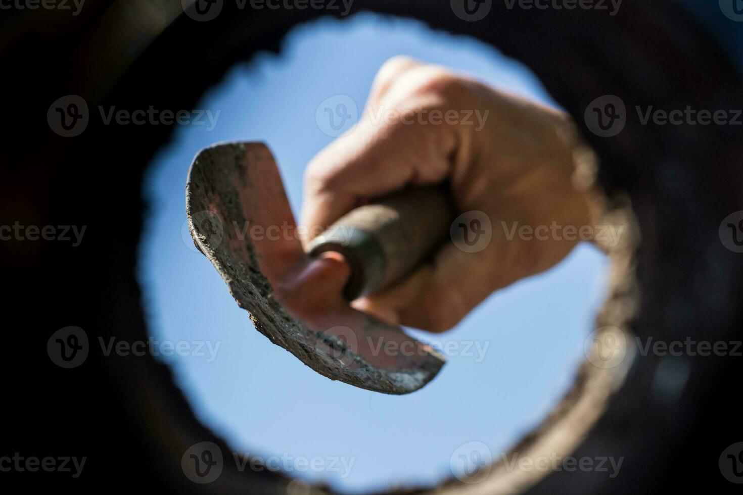 the hardworking hand that cultivates the garden seen from the inside of the earth photo