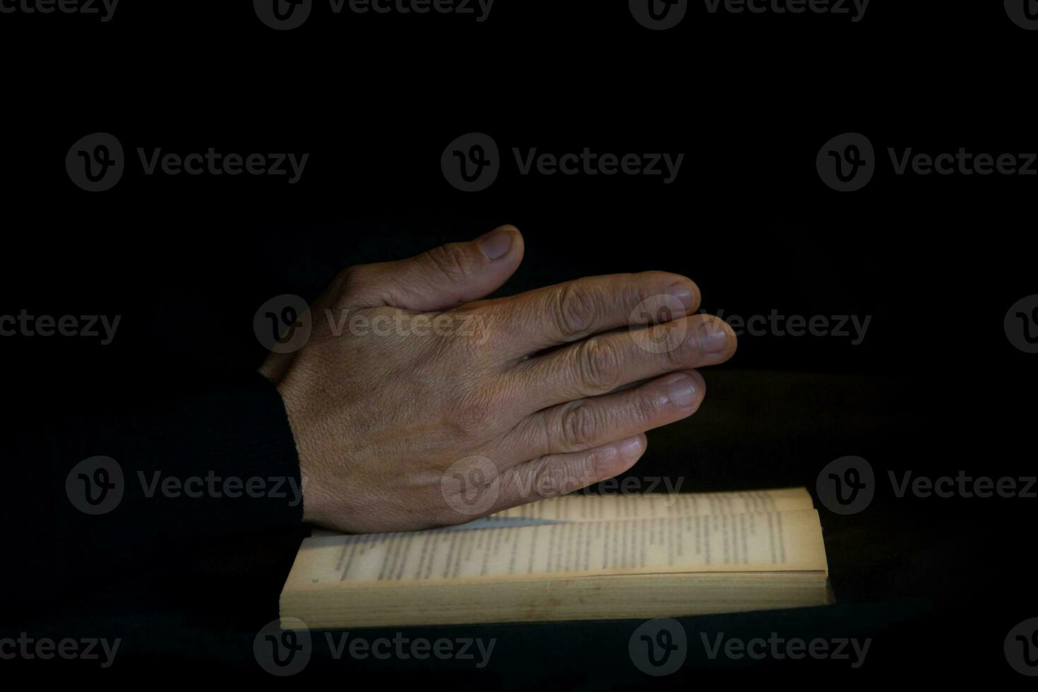 praying hands on black background photo