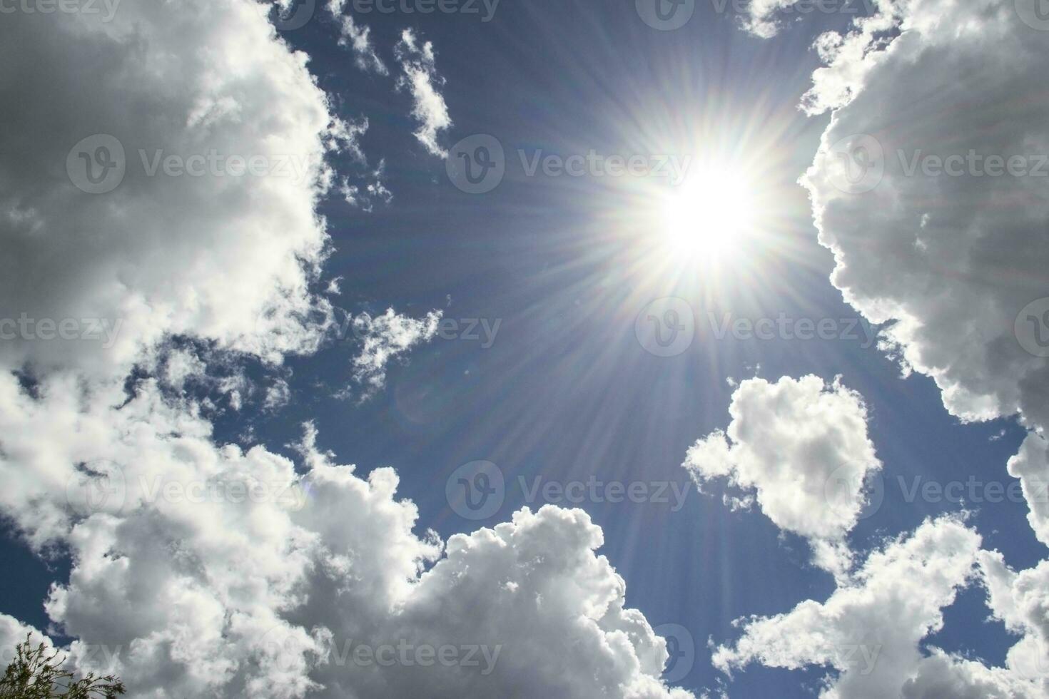 heavenly sky between the white clouds and the radiant sun photo