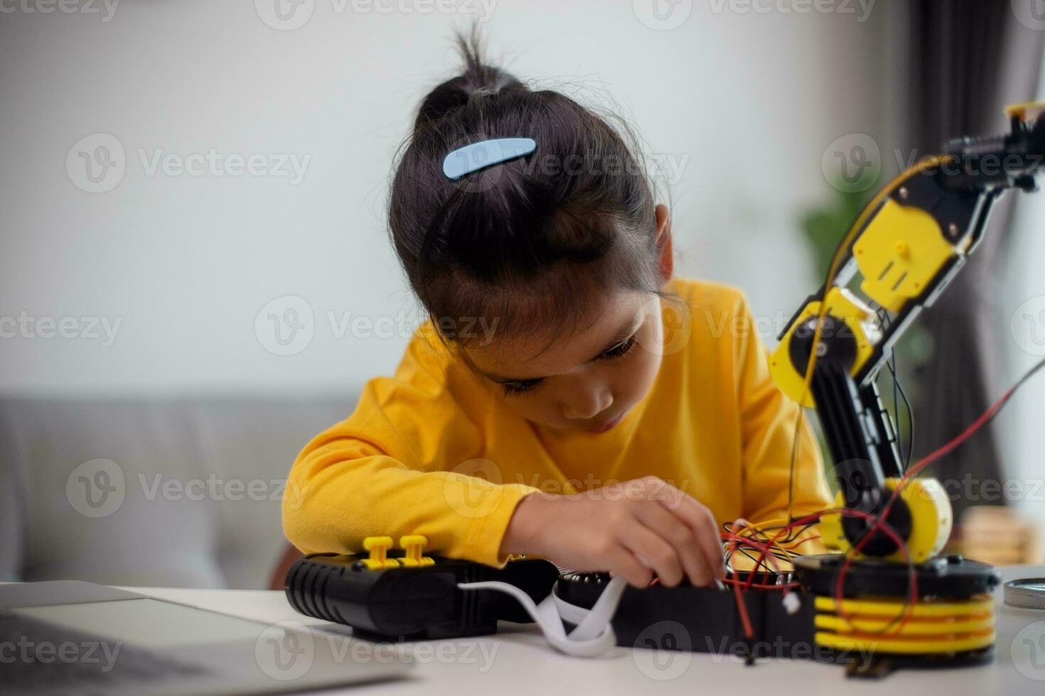 STEM education concept. Asian students learn at home by coding robot arms in STEM, mathematics engineering science technology computer code in robotics for kids' concepts. photo