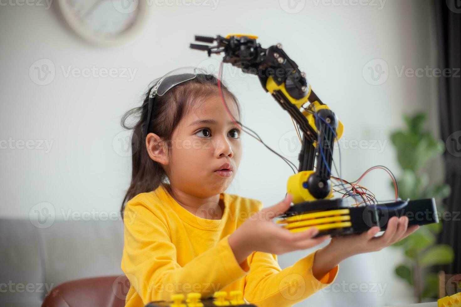 STEM education concept. Asian students learn at home by coding robot arms in STEM, mathematics engineering science technology computer code in robotics for kids' concepts. photo