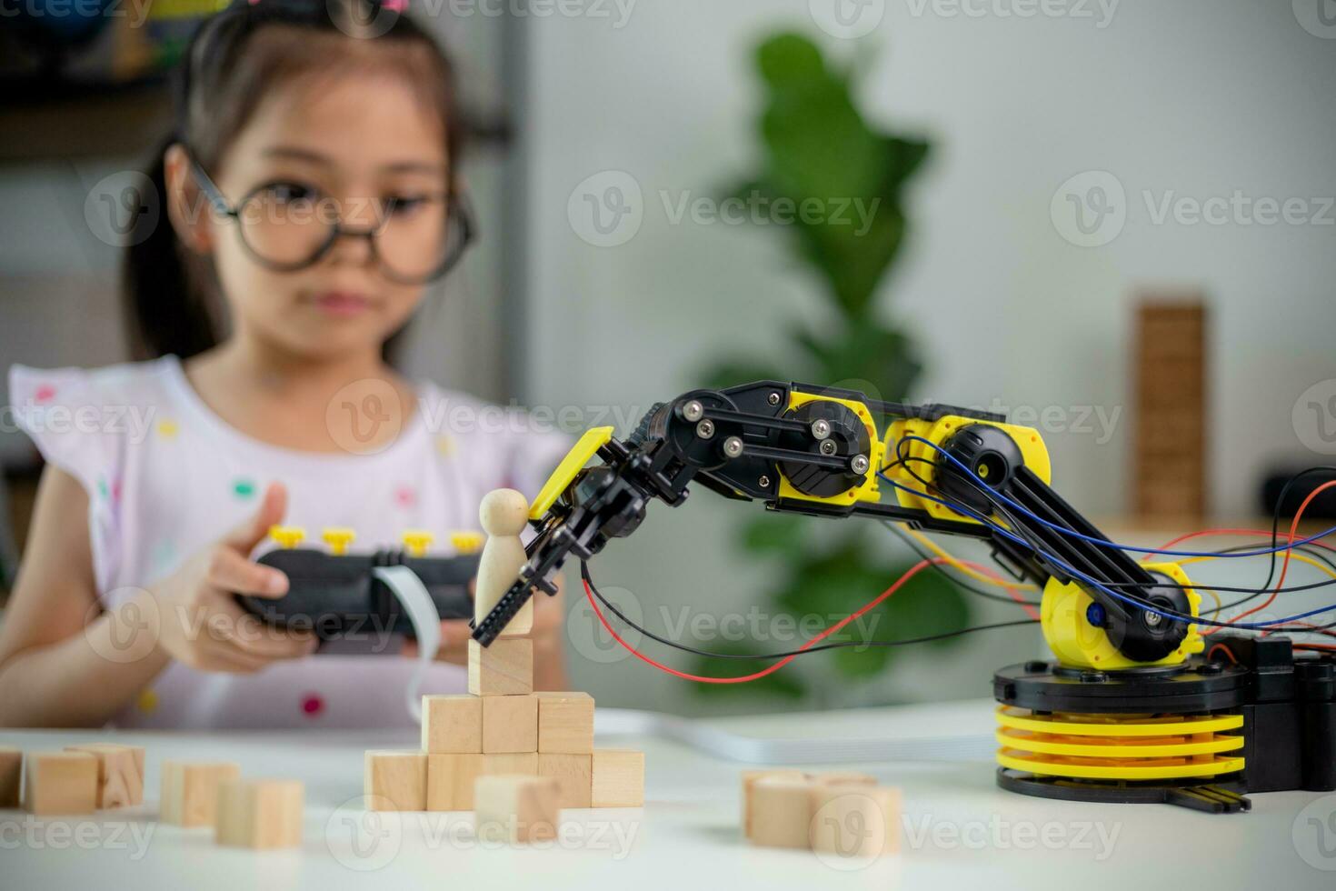 STEM education concept. Asian students learn at home by coding robot arms in STEM, mathematics engineering science technology computer code in robotics for kids' concepts photo