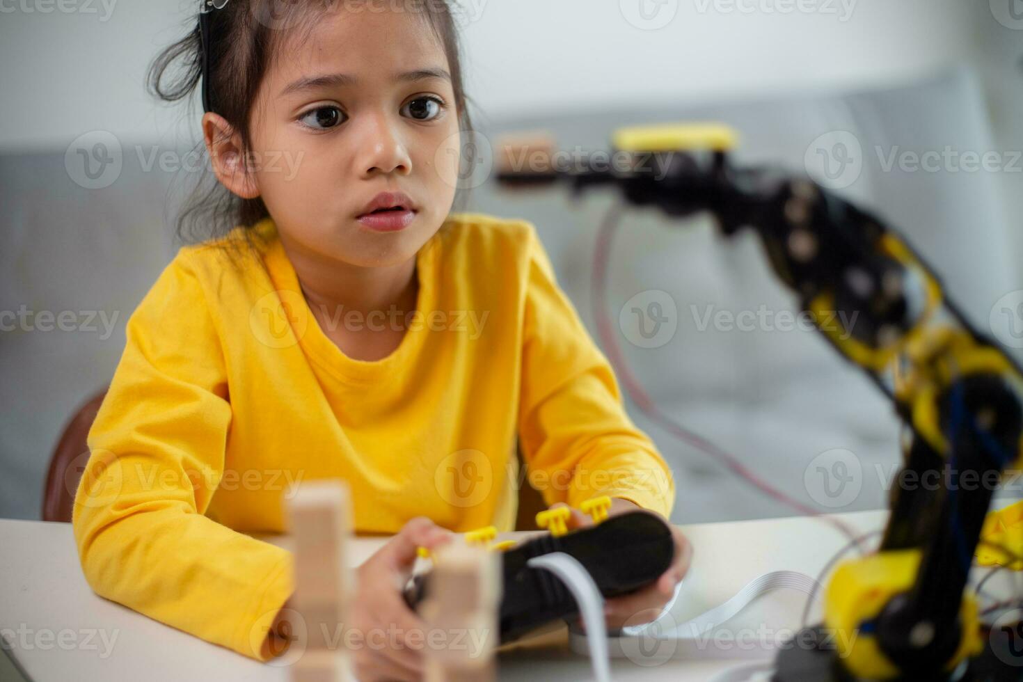 STEM education concept. Asian students learn at home by coding robot arms in STEM, mathematics engineering science technology computer code in robotics for kids' concepts. photo
