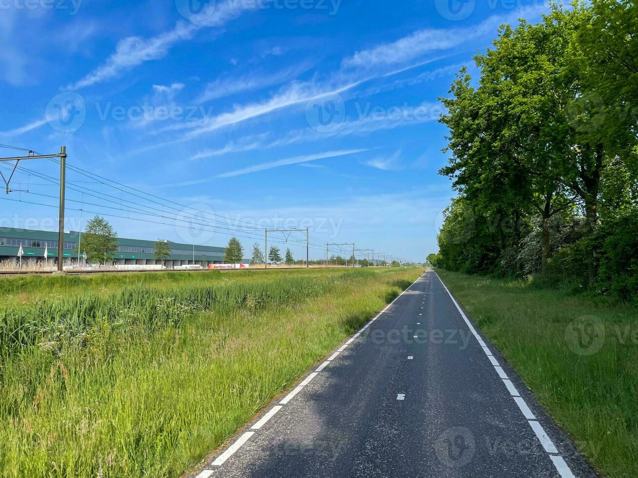 Pedal alongside the rhythmic flow of trains on a bike lane parallel to the tracks, where adventure and urban vibes converge in a unique and dynamic journey photo