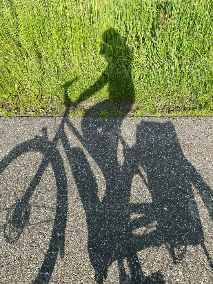 Discover the exhilarating world of biking through captivating shadows, where the interplay of light and motion creates a stunning visual spectacle photo