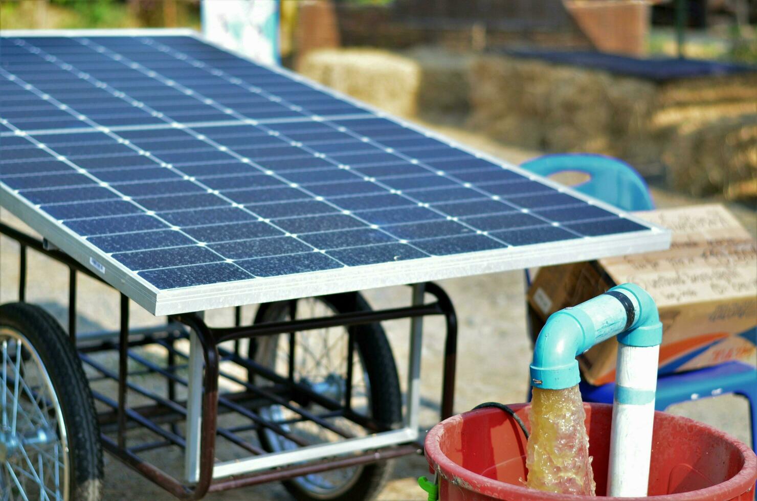 Water pumps and moveable solar panels. Groundwater is pumped with a submersible pump from clean energy or solar energy converted to electric energy on a small agricultural farm. photo