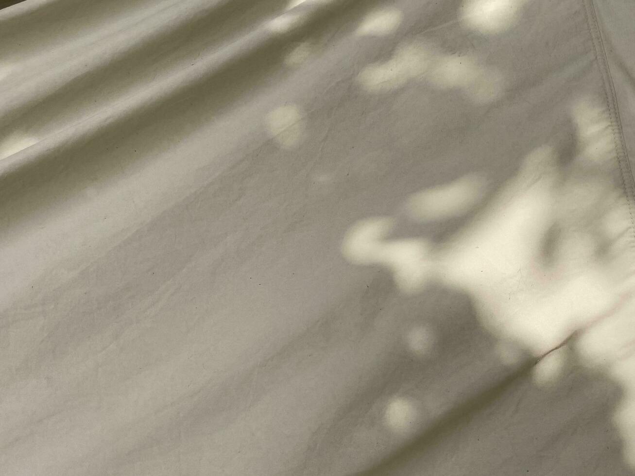 Leaves shadow background on cloth texture, leaves tree branches shade photo
