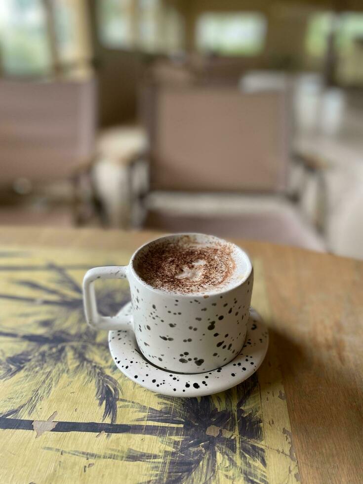 Hot coffee cup on wooden table photo