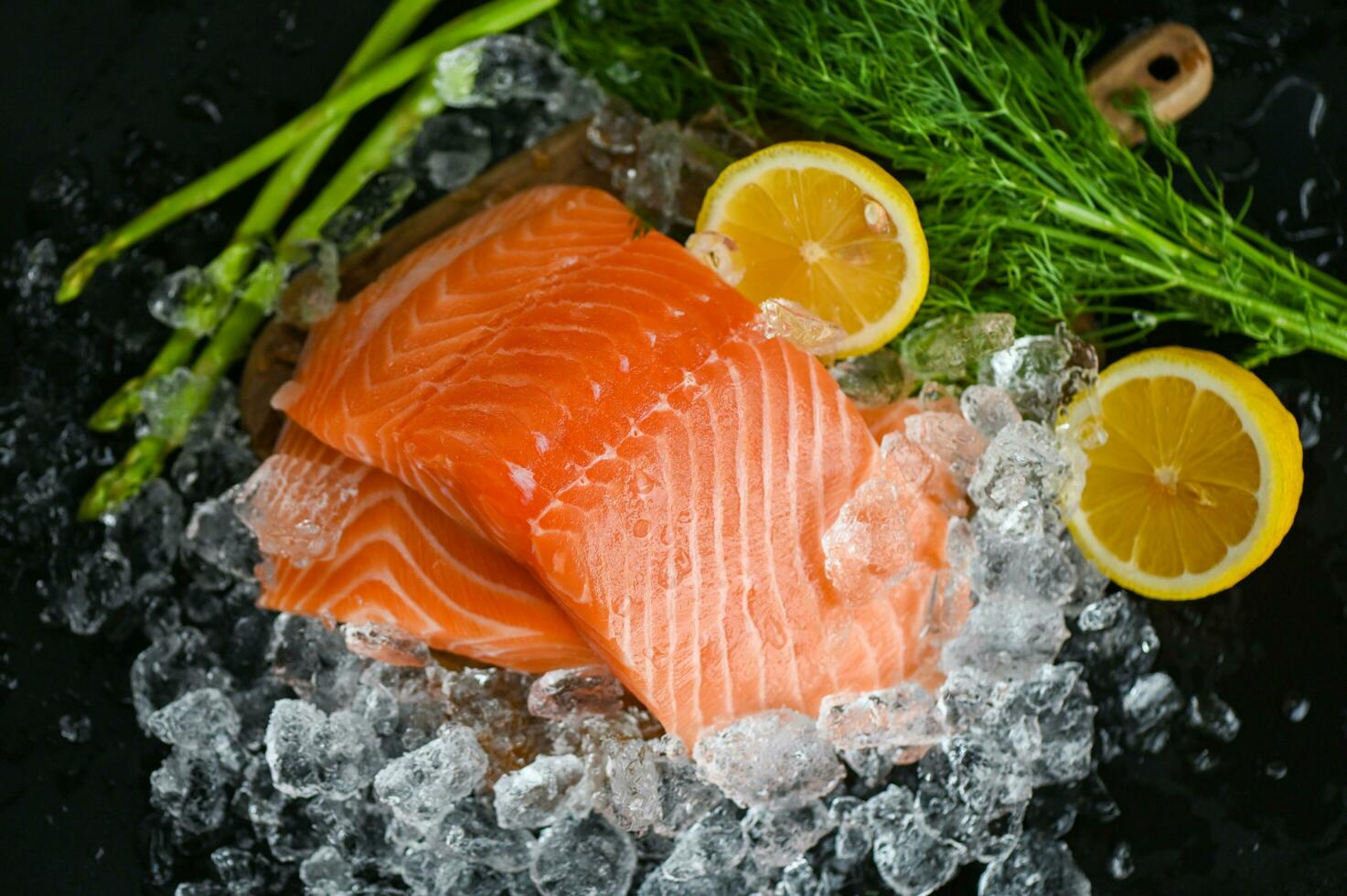 salmon fillet with lemon asparagus herb and spices, fresh raw salmon fish on ice for cooking food seafood salmon fish photo