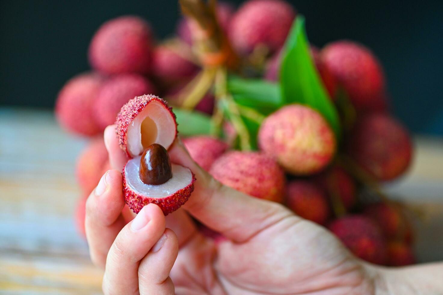 fresh ripe lychee fruit tropical fruit peeled lychees slice in Thailand, lychees on hand photo