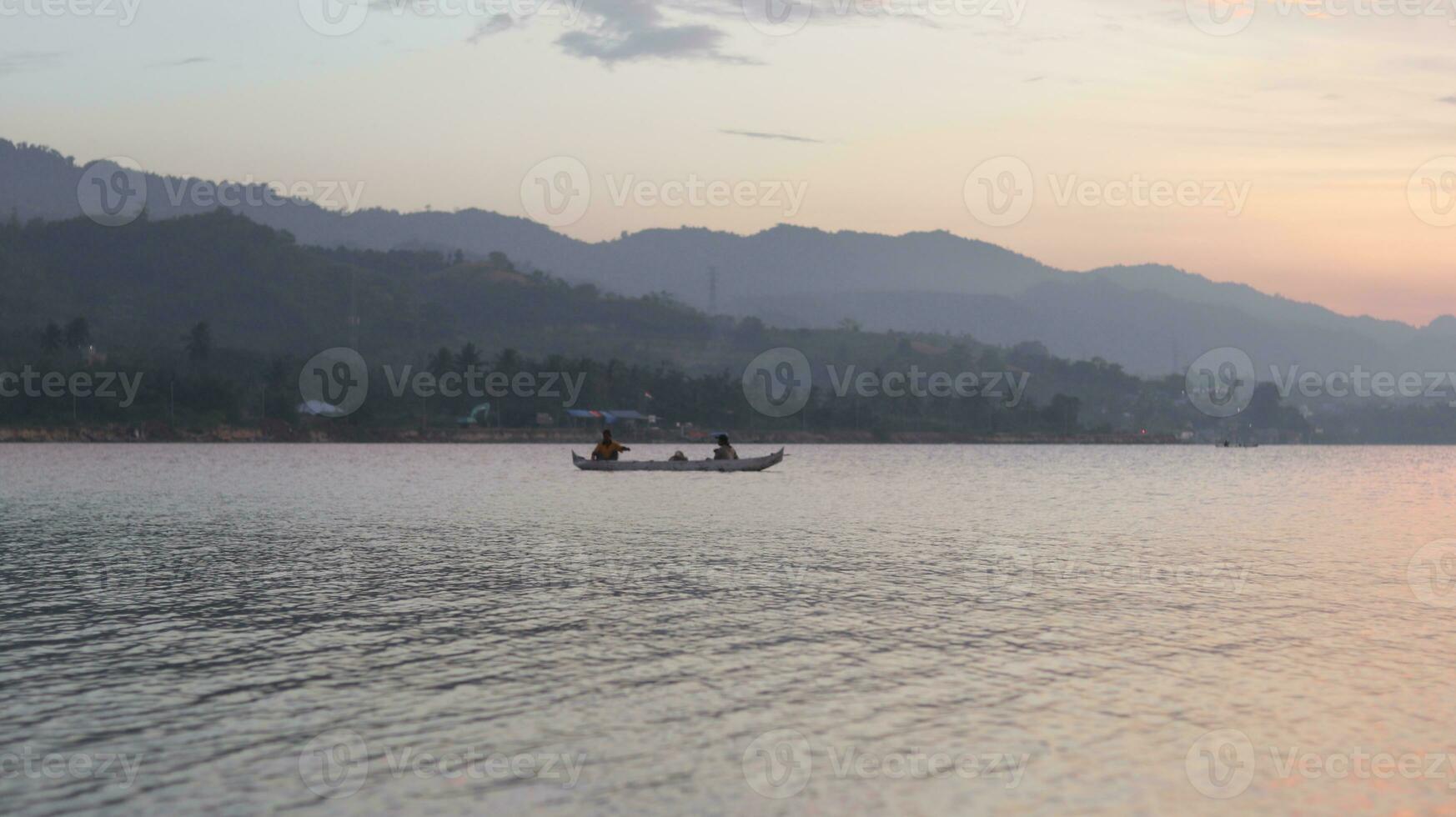 Fisherman Silhouette on His Boat photo