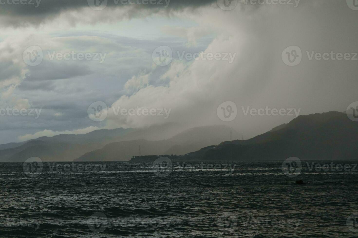 storm over the sea with mountains in the background photo