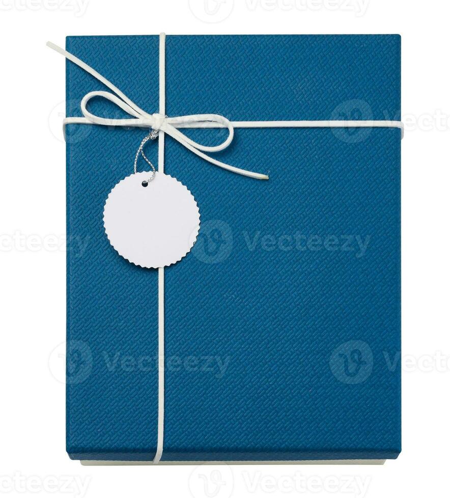 Blue cardboard gift box with a lid and a tag on a white isolated background, top view photo