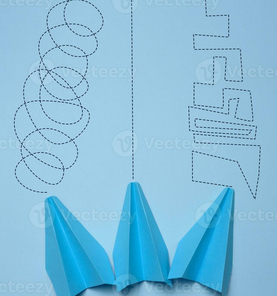 Three paper blue planes with different trajectories, the concept of reaching the goal photo