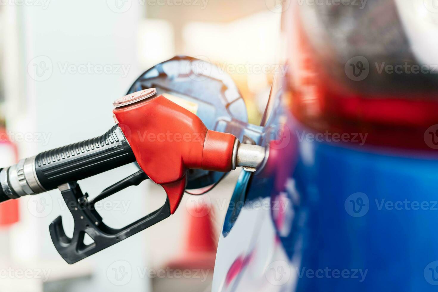 Car fueling at gas station. Refuel fill up with petrol gasoline. Petrol pump filling fuel nozzle in fuel tank of car at gas station. Petrol industry and service. Petrol price and oil crisis concept. photo