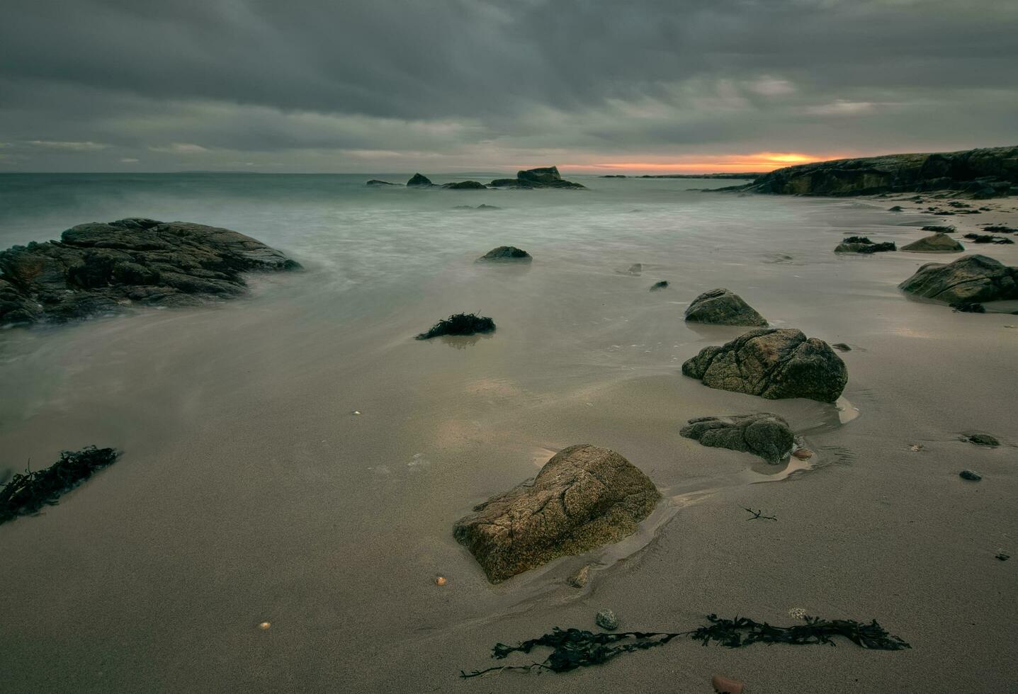 Dramatic cloudy sunset scenery of rocky at wild atlantic way, Seaweed beach in County Galway, Ireland photo