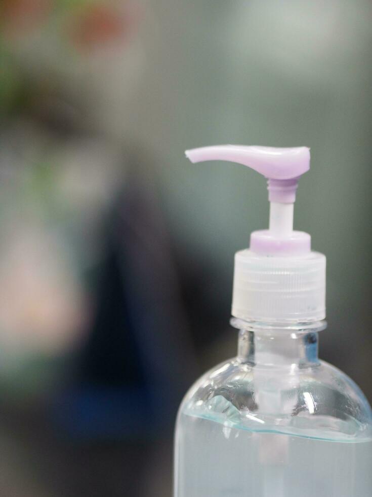 Hand Sanitizer, gel alcoholic mixture with gelatin in clear Plastic bottle with pump pushing wash clean dirty to prevent germs protect Contagious disease corona virus, covid-19 photo