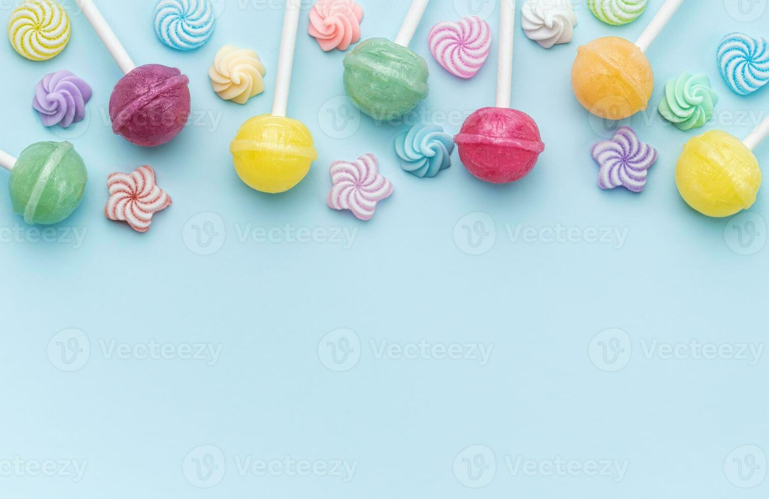 Sweet lollipops and candies on blue background photo