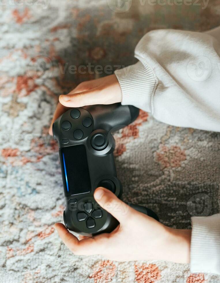 Girl playing video game at home photo