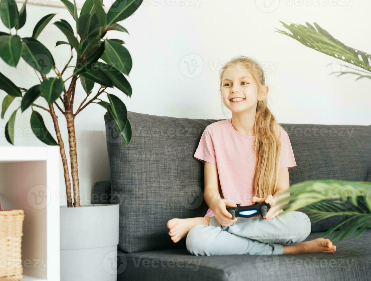 Girl playing video game at home photo