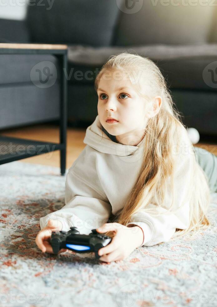 Girl playing video game at home photo