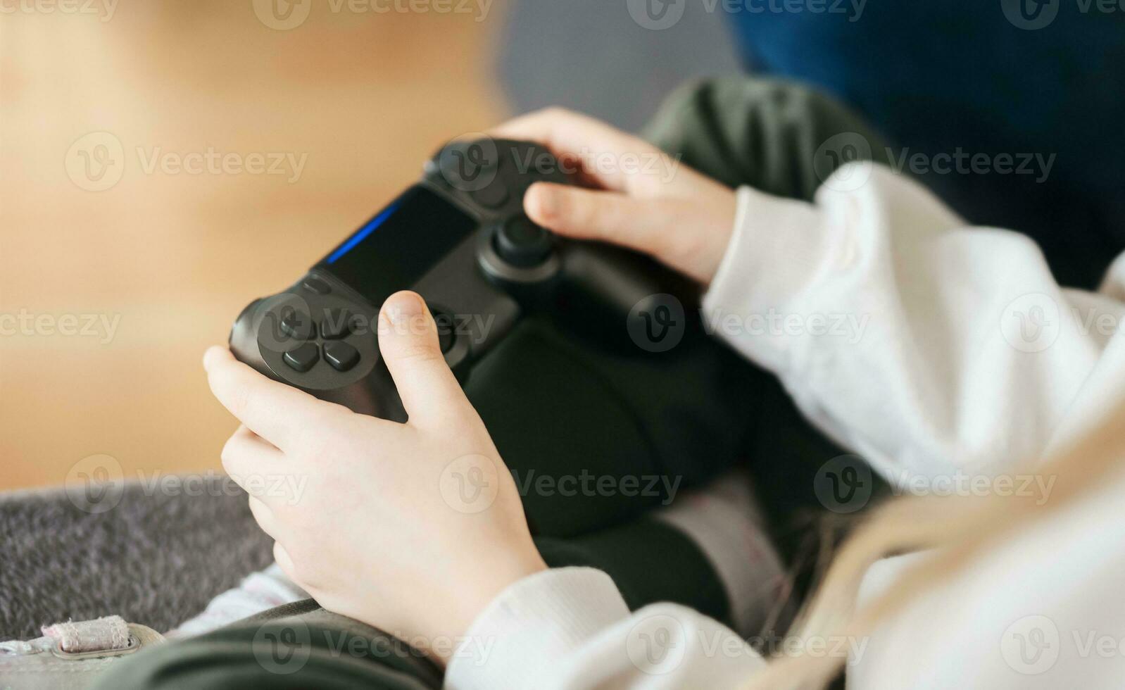 Little girl playing on games console photo